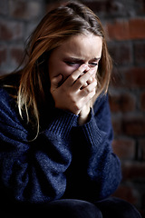 Image showing Woman, abuse and crying with hands, scared and alone with fear, hiding and afraid. Toxic relationship, shame or home for physical assault, problem or domestic violence with terror, anxiety or pain