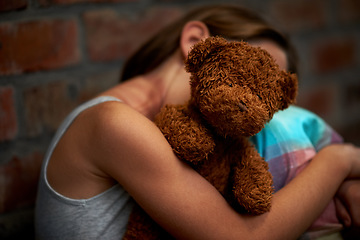 Image showing Abuse, girl and child with fear, teddy bear and stress with depression, anxiety and bullying. Person, kid and victim with a toy, home and sad with mental health, crisis and trauma with development