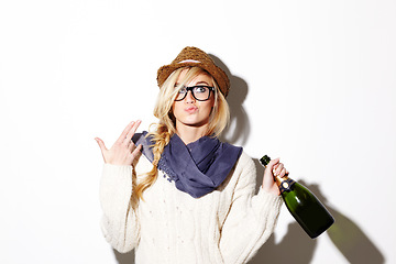 Image showing Woman, blonde and hat with champagne of nerd, geek or hipster thinking against a studio background. Attractive female person with glasses, nerdy or fashion style gesture and holding bottle of alcohol