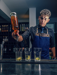 Image showing Bartender making cocktail