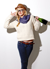 Image showing Champagne, drunk or portrait of woman in studio for a fun celebration, party or adult event. Face, hand gun or wild person drinking alcohol or beverage in bottle for New Year on white background