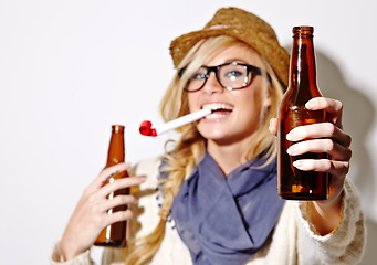 Image showing Beer, portrait or happy woman with party horn for fun celebration, holiday or hipster event in studio. New year, giving or hands of person drinking alcohol or beverage in bottle on white background