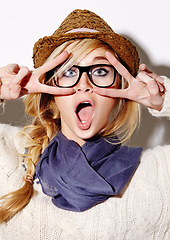 Image showing Portrait, wow and peace sign with an excited woman in studio on a white background feeling silly or goofy. Face, surprise and expression with a quirky young person closeup for fashion or fun