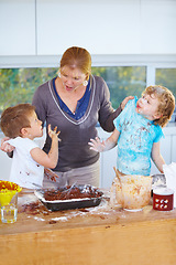 Image showing Family, baking and a mother scolding her children for the mess in a home kitchen with naughty boys. Food, cake or ingredients with a woman yelling at her kids while cooking in an untidy apartment