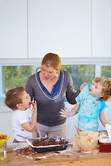 Image showing Family, baking and a mother yelling at her children for the mess in a home kitchen with naughty boys. Food, cake or ingredients with a woman scolding her kids while cooking in an untidy apartment