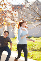 Image showing Woman run, autumn and nature at park with smile and happy from travel, vacation and leaves. Holiday, outdoor and calm female person in New York with freedom and adventure by a tree in a garden