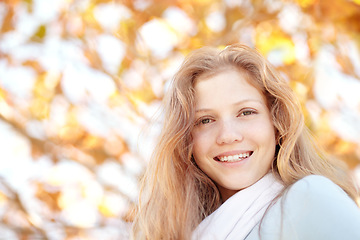 Image showing Woman, autumn and nature at park with portrait and happy from travel, vacation and colorful leaves. Holiday, outdoor and female person smile in New York with freedom and adventure by tree in garden