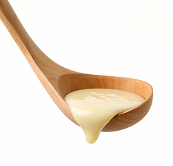 Image showing condensed milk in wooden ladle