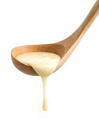 Image showing condensed milk in wooden ladle