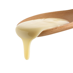 Image showing condensed milk in wooden spoon