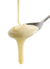 Image showing condensed milk pouring in spoon