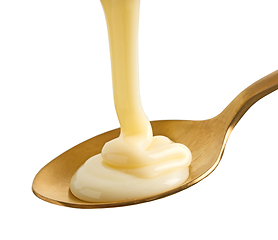 Image showing condensed milk in golden spoon