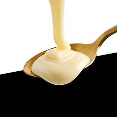 Image showing condensed milk pouring into spoon