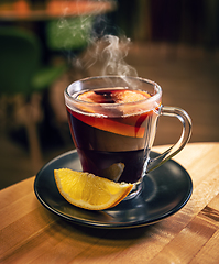 Image showing Mulled wine with orange in glasses.