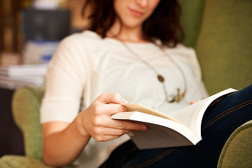 Image showing Reading, books and hands on sofa in library, bookstore or shop for research, learning and relax on couch. Literature, customer and person with book for education, information and knowledge for hobby