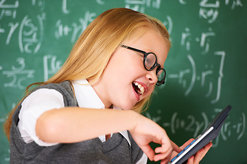 Image showing child, student and calculator by chalkboard for happy education, learning and problem solving or solution. Smart girl or child with glasses and excited for school, typing numbers or math in classroom