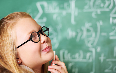 Image showing Thinking, chalk and kid student with brainstorming by board for planning, decision or solution in classroom. Education, learning and girl child with drawing for choice, vision or future in school.