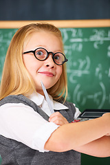 Image showing Thinking, math and child student in classroom with idea, solution or brainstorming facial expression. Smile, education and young girl kid with glasses for learning or planning with board in school.