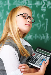 Image showing GIrl, portrait and calculator by chalkboard for education, learning and problem solving or solution with confidence. Smart kid, student or child with glasses for school, numbers and math in classroom