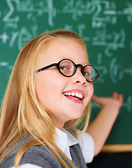 Image showing Smile, portrait and child student in classroom with idea, solution or brainstorming facial expression. Happy, education and young girl kid with glasses for learning or planning with board in school.