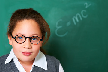 Image showing Portrait of student, geek and kid by chalkboard in class for learning knowledge, education and study math on mockup space. Face, glasses and nerd at school, girl or cute child in classroom in Spain