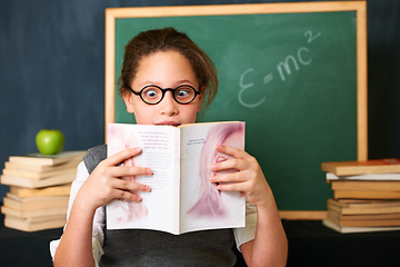 Image showing Shock, reading and child student with a book in the classroom for education, learning or knowledge. Study, nerd and girl kid with glasses enjoying a story or novel with surprise face at school.