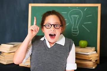 Image showing Solution, idea and portrait of student with light bulb on board for plan, decision or brainstorm in classroom. Education, learning and girl child with drawing for choice, vision or future in school.