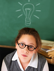 Image showing Thinking, idea and portrait of student with light bulb on board for plan, decision or brainstorming in classroom. Education, learning and girl kid with drawing for choice, vision or future in school.