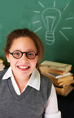 Image showing Thinking, smile and student with light bulb on board for planning, decision or brainstorming in classroom. Education, learning and happy girl child with drawing for choice, vision or future in school