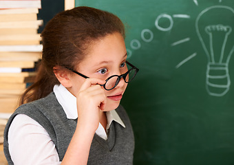 Image showing Shock, idea and student with light bulb on board for planning, decision or brainstorming in classroom. Education, learning and surprised girl child with drawing for choice, vision or future in school