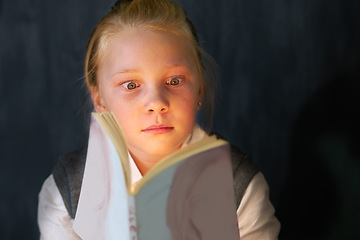 Image showing Surprise, reading and child student with a book in the classroom for education, learning or knowledge. Study, nerd and young girl kid enjoying a story or novel with shock face at school or academy.