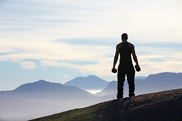 Image showing Fitness, weightlifting and back of man with dumbbells on mountain top for morning cardio on sky background. Weights, freedom and rear view of male bodybuilder in nature for training, power or workout