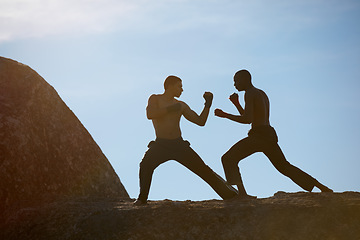 Image showing Mountain, fitness and karate men training in nature for body, speed or sparring technique on blue sky background. Martial arts, taekwondo or MMA friends outdoor for morning cardio, exercise or sports