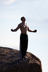 Image showing Mountain top, fitness man and freedom with winner fist in nature for training, wellness or sports on sky background. Exercise, success and male athlete with cardio, gratitude or workout celebration
