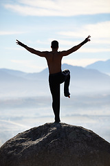 Image showing Karate, balance and fitness man on mountain top for body training, power or workout on blue sky background. Martial arts, MMA and male taekwondo master in nature for exercise, sport or morning cardio