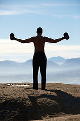 Image showing Weightlifting, fitness and back of man with dumbbells on mountain top for morning cardio on sky background. Weights, energy and rear view of male bodybuilder in nature for training, power or workout