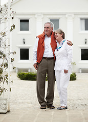 Image showing Hug, smile and old couple outside hotel, villa and luxury hospitality on retirement vacation together. Marriage, travel and holiday accommodation, senior man and woman embrace in courtyard in Italy.