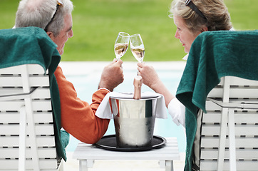 Image showing Mature, man and woman with champagne for cheers in celebration of retirement on vacation at resort. Senior couple, love and romance for relationship, bonding and relaxing for quality time together