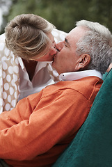 Image showing Kiss, love and senior couple relax in a backyard with freedom, fun and bonding at home together. Gratitude, care and old people with passion, security or support in a yard sharing a romantic moment