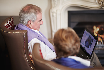 Image showing Relax, senior couple with laptop in hotel lounge or restaurant checking social media on retirement vacation. Computer, old man and woman at fireplace in cozy holiday accommodation with online search.