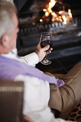 Image showing Relax, senior man with wine at fireplace in hotel lounge or cozy room on retirement vacation. Luxury hospitality, elderly person with glass or drink at holiday accommodation with peace, calm and fire