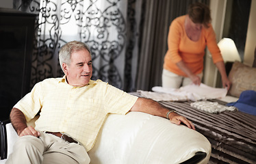 Image showing Hotel, senior man and woman packing clothes in bedroom on retirement holiday chat together. Travel, vacation and happy old couple unpacking with bed, sofa and relax with luxury hospitality in room.