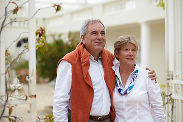 Image showing Embrace, smile and old couple outside hotel, villa and love on luxury retirement vacation together. Marriage, travel and romantic holiday accommodation, senior man and woman in courtyard hugging.