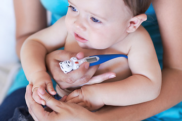 Image showing Baby, armpit and thermometer to measure of fever for sick with parent while holding hand in trust. Mother, infant and childcare for health, treatment or test of virus, illness or infection at home