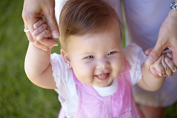 Image showing Baby, steps and happy in garden with help of mom, holding hands and walking outdoor. Child, development and girl laughing and smile on grass, lawn or standing with support of mother to guide movement