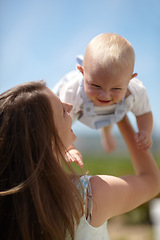 Image showing Woman, lift baby outdoor and happy with care, love and bonding on holiday, summer sunshine and playing together. Mother, infant child and comic laughing in backyard, park or family garden in spring