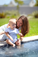 Image showing Pool, water and mom with baby in garden or child splash with legs for fun, game or experience. Happy kid, swimming and mother outdoor with son dipping toes in pond, liquid or playing in backyard