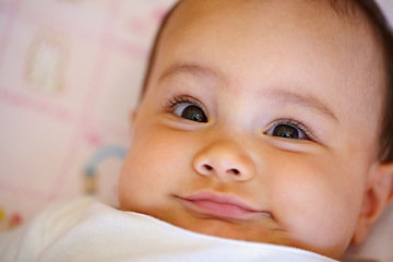 Image showing Smile, portrait and a baby on a bed for playing, wake up and cozy in the morning. Happy, youth and face of a girl, infant kid or child in the bedroom of a house to relax with comfot in childhood