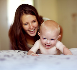 Image showing Laughing, playing and a mother with a baby on the bed for bonding, love and care in the morning. Wake up, smile and a mom with a kid or family together in the bedroom of a house for happiness