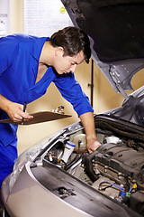 Image showing Checklist, man and technician check engine of car, repair and maintenance. Clipboard, mechanic and serious person on motor vehicle hood, fixing transport and inspection list at auto service garage